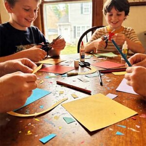 Kids doing paper crafts at the kitchen table